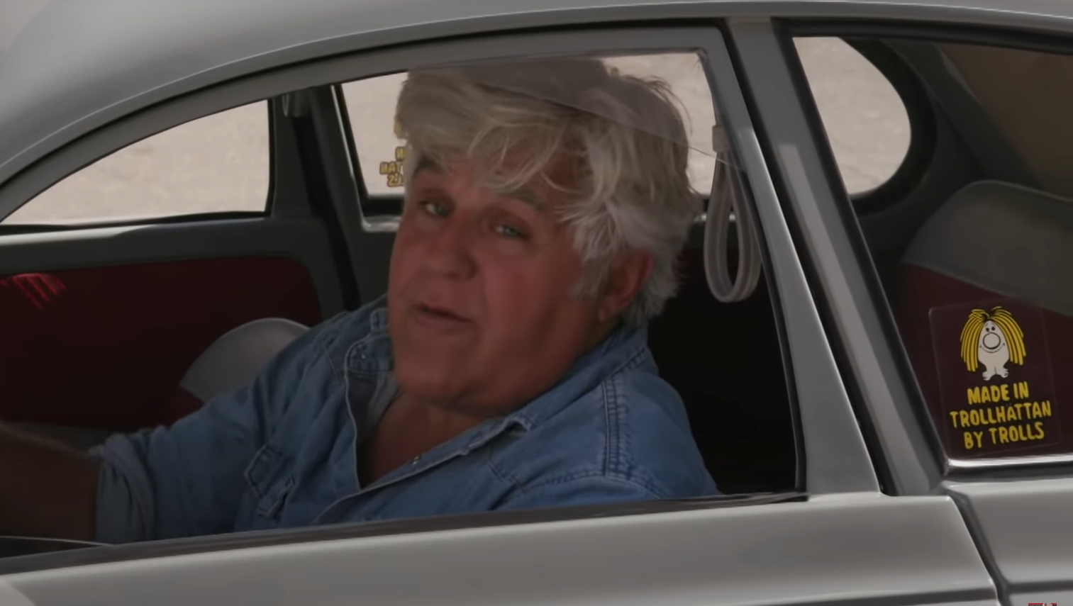 Jay Leno in his Saab. Window sticker says "Made in Trollhättan by trolls".